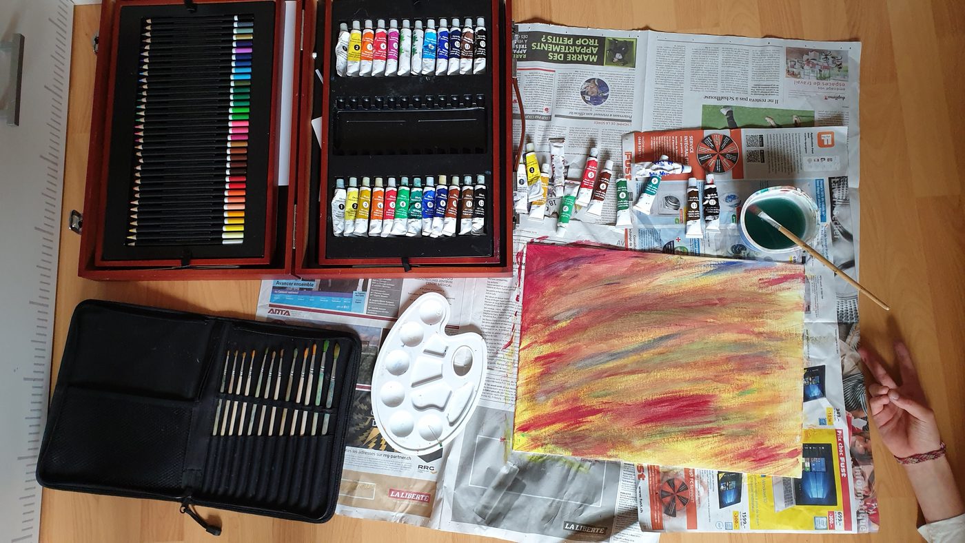 Réka's art supplies — pencils, oil paints, brushes, and a canvas in progress