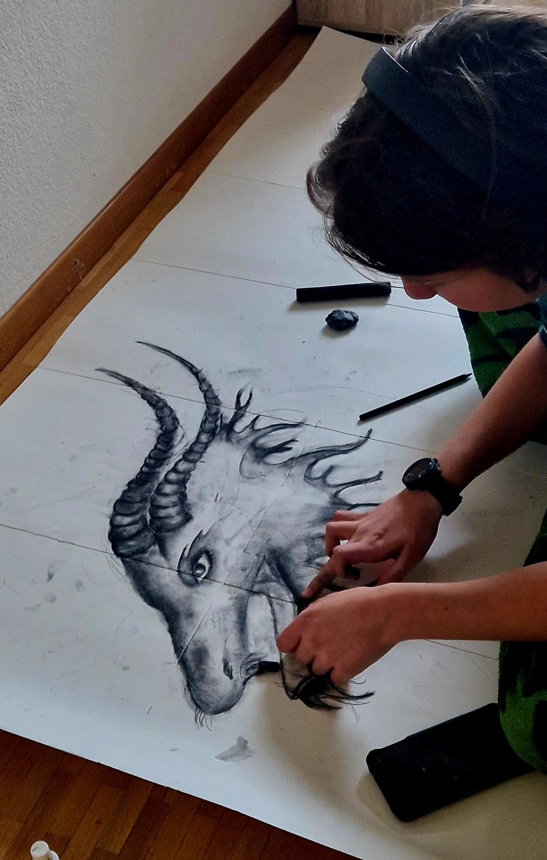 Réka drawing on the studio floor